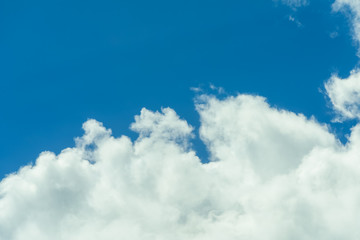 Beautiful puffy clouds at sunset isolated against pastel blue skies