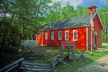 Red schoolhouse in rustic setting, MI