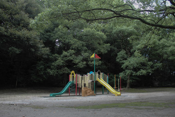 playground surrounded by trees in the park kagoshima japan daytime sunny weather