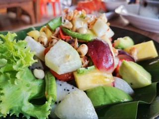 Thai food, Papaya Salad with Mixed Fruits, Avocado, Purple grape, Dragon fruit, Pineapple and Fruit Wheelbarrow.