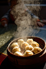 The steamed dumpling (Baozi) in a bamboo steamer. 