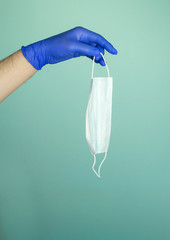 Hands in medical gloves on a blue background. Disease Protection Concept. Pandemic Protection...