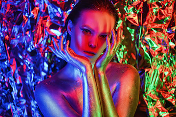 people are colored fluorescent powder. a pair of lovers dancing at a disco.