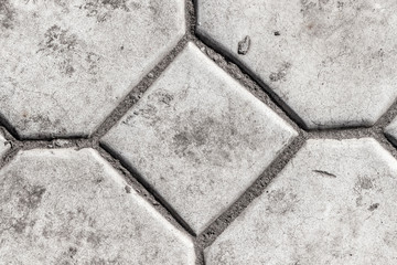Surface of gray concrete paving slabs closeup.