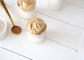 Iced frothy Dalgona Coffee, a trendy fluffy creamy whipped coffee. Korean drink latte espresso with coffee foam. cups and spoon with instant coffee and sugar. top view