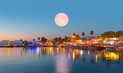 Resort town of Side at twilight blue hour with full moon - Grand bazaar Side, considered to be the...