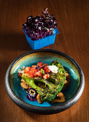 roasted vegetables with edible flowers and microgreens