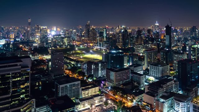 Bangkok business shopping district city center above Ratchadamri and Ratchaprasong area, with buildings and skyscrapers, during night, zoom out – Time Lapse