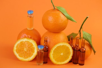 Vitamin C prevention of immunity from viruses.Vitamin C ampoules and fresh oranges and mandarin on...