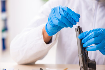 Male expert criminologist working in the lab for evidence