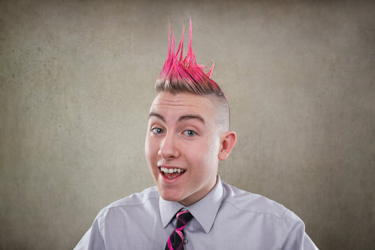 Smiling teen with a pink mohawk haircut