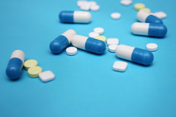 A lot of pills and pills on it on a blue background.