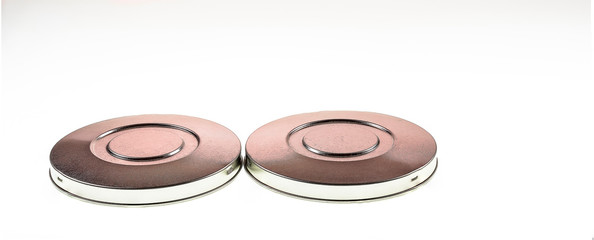 Metal disks isolated against a white background shot as an artistic backdrop.