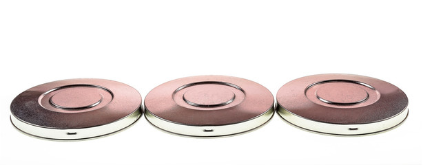 Metal disks isolated against a white background shot as an artistic backdrop.