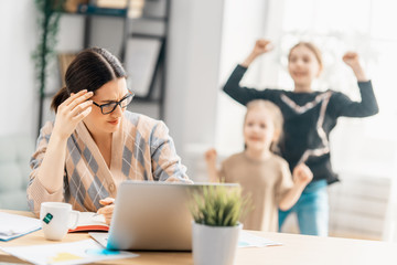 Woman working on a laptop.