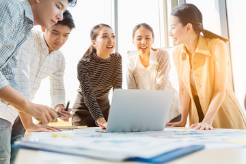 Group of asian young modern people in smart casual wear having a brainstorm meeting while sitting in office background. Business meeting, Planning, Strategy, New business development, Startup concept.