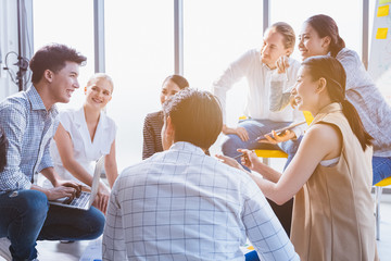 Group of asian young modern people in smart casual wear having a brainstorm meeting while sitting in office background. Business presentation, Planning, Strategy, New business development, Startup