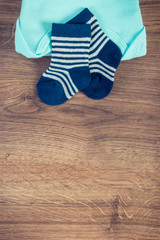 Clothing for newborn, concept of expecting for baby, place for text. Vintage photo