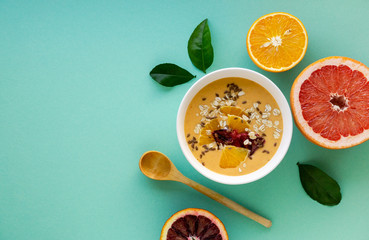 Citrus smoothie bowl with grapefruit and orange on a blue background