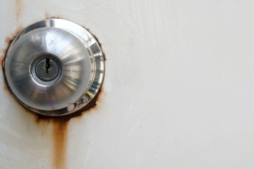 Close-up a master key locking vintage on metal wall was rusting because was weathering.