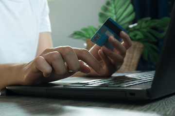 Hands holding credit card and using laptop. Online shopping. work from home concept