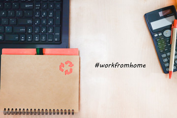Close view of office table with laptop and notebook and calculator isolated on wooden background. 
 Work from concept.