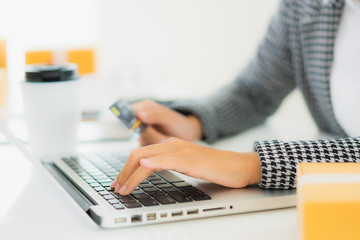 Portrait beautiful young asian woman use credit card with laptop for online shopping