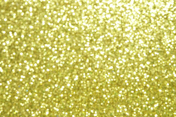 gold Sparkling Lights Festive background with texture. Abstract Christmas twinkled bright bokeh defocused and Falling stars. Winter Card or invitation.