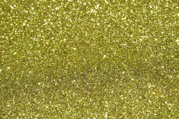 gold Sparkling Lights Festive background with texture. Abstract Christmas twinkled bright bokeh defocused and Falling stars. Winter Card or invitation.