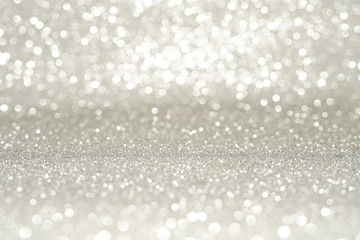 silver Sparkling Lights Festive background with texture. Abstract Christmas twinkled bright bokeh defocused and Falling stars. Winter Card or invitation.