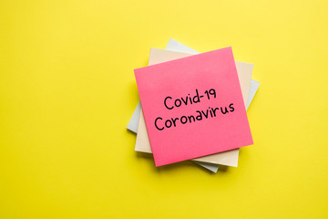 Covid-19 - Coronavirus, note on yellow background