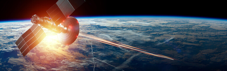 Space military satellite, a weapon in space shoots a laser against the background of the earth....