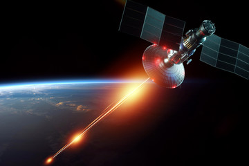Space military satellite, a weapon in space shoots a laser against the background of the earth. Attack, technology, space war. mixed medium, copy space. image furnished by NASA. © Aliaksandr Marko