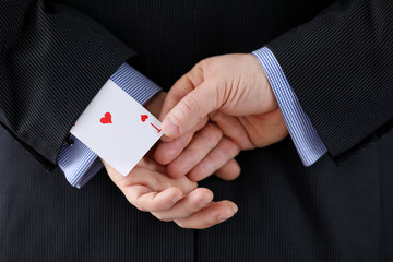 Close up man suit holds ace card behind his back. Identification exposure targets. Mastery methods...