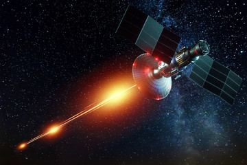 Space military satellite, a weapon in space shoots a laser against the background of the earth....