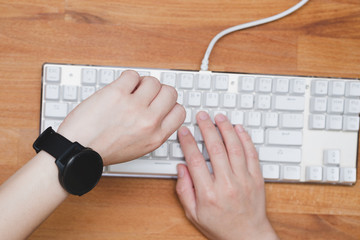 typing on keyboard and Looking at the watch