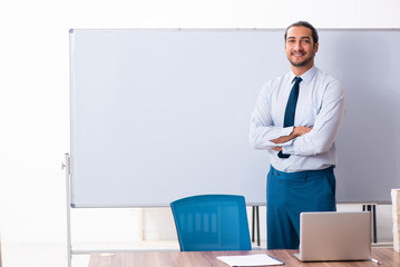 Young male employee in business presentation concept