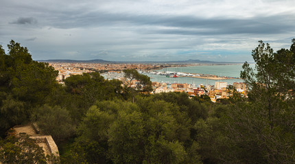 Fototapeta na wymiar Panorama of Palma de Mallorca with the port and the cathedral on a cloudy day in spring. View from castell de bellver.