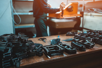 people working with press machinery for cutting shoe leather