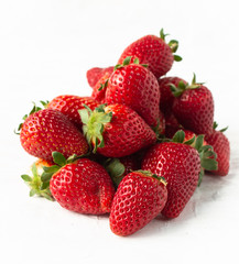 Pile of strawberries on white
