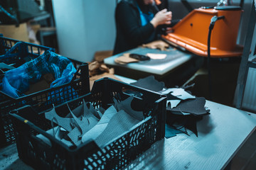 people working with press machinery for cutting shoe leather