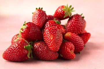 Pile of strawberries on pink background