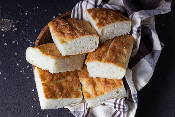 Traditional Italian focaccia bread with salt and olive oil. Homemade flat bread focaccia. Focaccia Genovese. 
