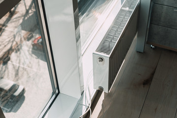 white radiator battery in the office near the window.