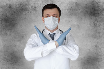 Doctor wearing protection face mask against coronavirus isolated over grey background. Medical staff preventive gear.