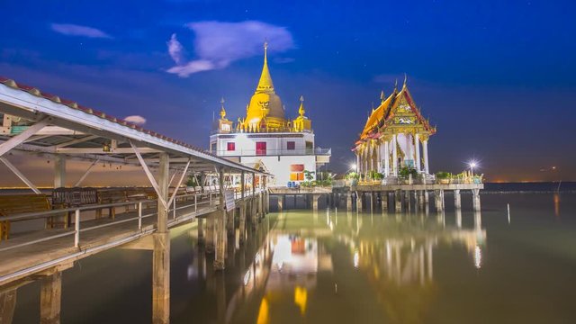 Time lapse of thai temple building located on the sea at sunrise timing under clody sky location at chachoengsao province of thailand