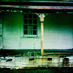 Exterior view of an abandoned derelict falling down house 