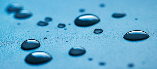Drops of water on a white rough surface.