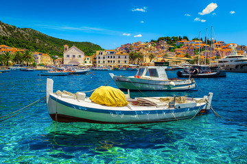 Fototapeta na wymiar Mediterranean harbor with fishing boats and luxury yachts, Hvar, Croatia