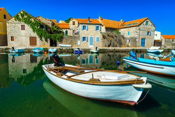 Fototapeta na wymiar Vrboska mediterranean resort with stone houses and fishing boats, Croatia